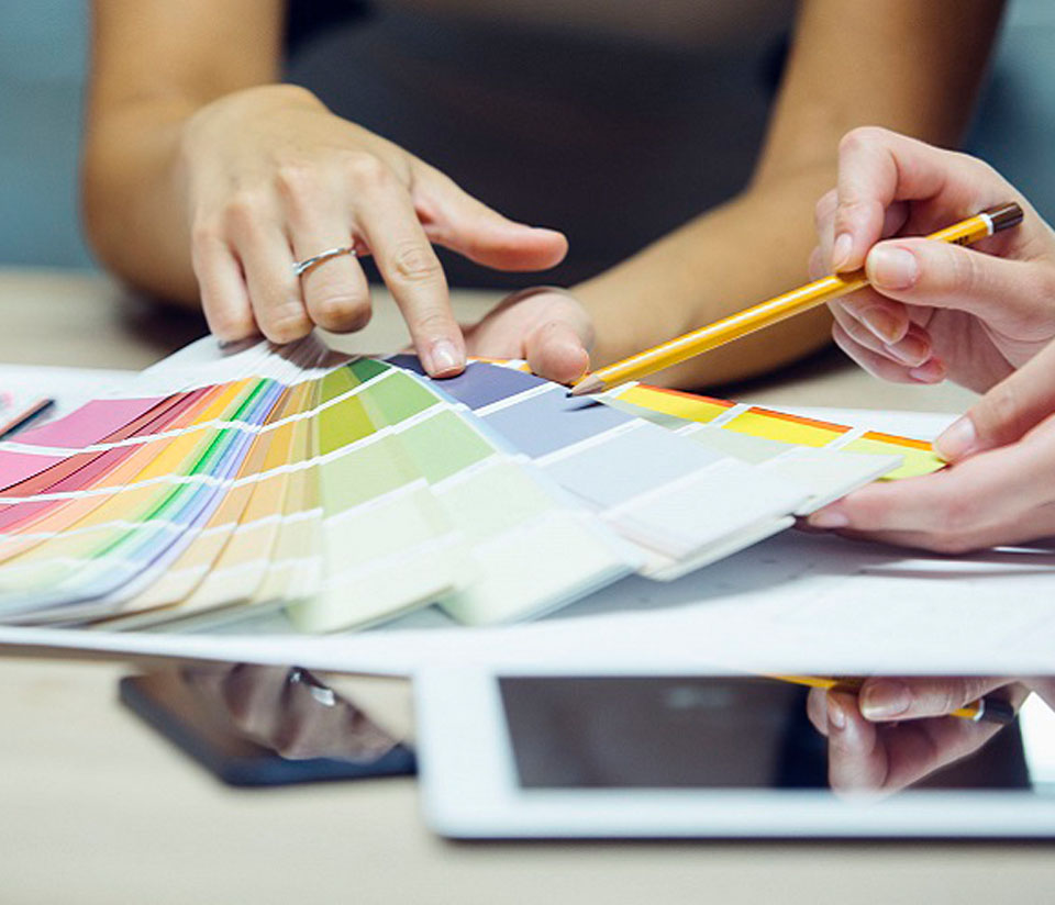 Image showing a close up of two people hands choosing paint colors